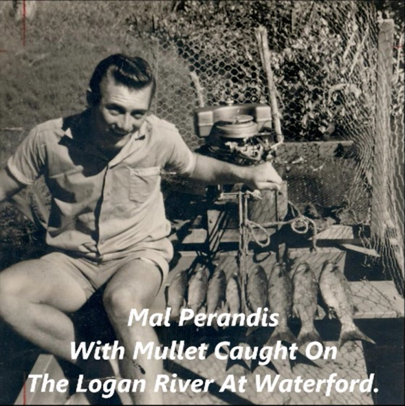 A black and white picture of a man in a boat holding fish